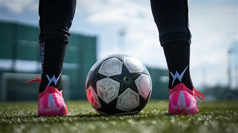 Játékos dinamikus mozgásban, futballlabdával a tökéletes focicipőben