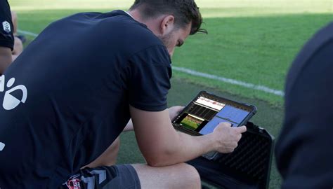 Kép egy futballedzőről, aki taktikai jegyzeteket olvas és elemez