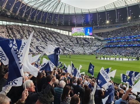 A Tottenham Hotspur stadionja, a háttérben kék égbolt és a klub logója