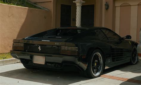 Michael Jordan szivarozik egy Ferrari előtt